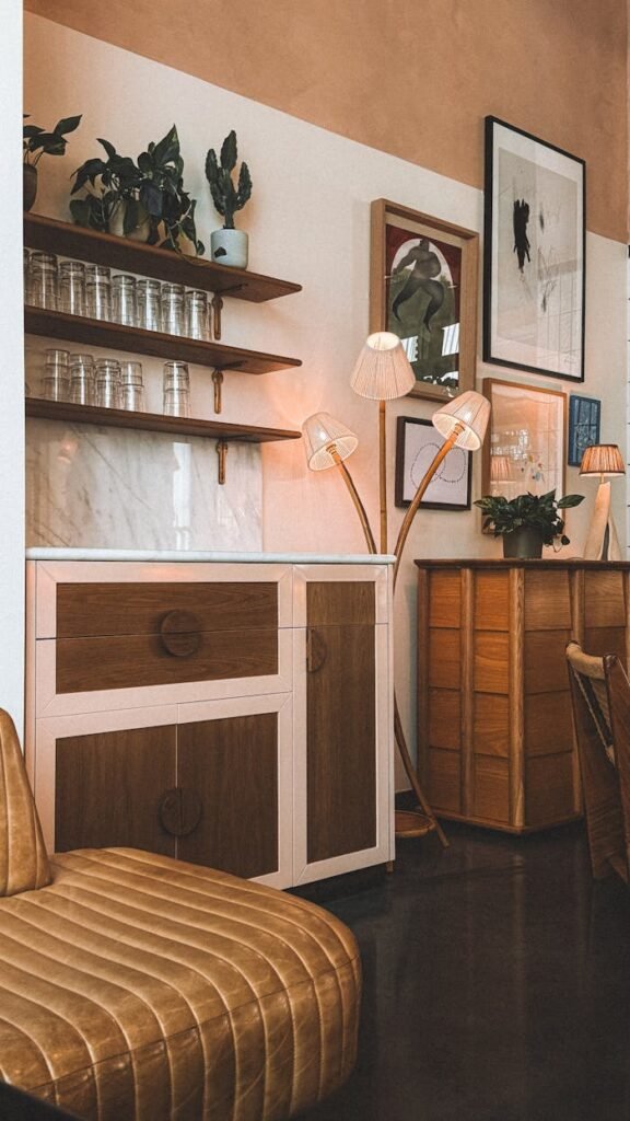 Warm, vintage-styled cafe interior in Barcelona with plants and cozy lighting.